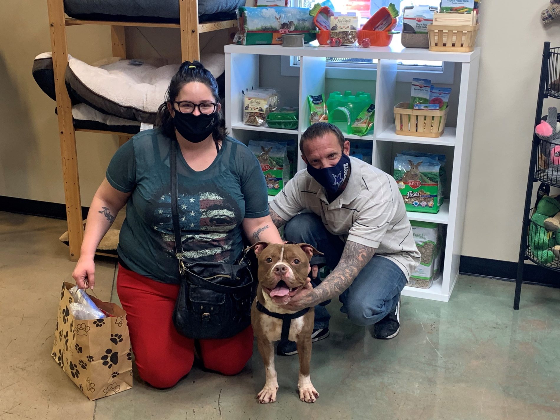 Two people adopting a dog at AHS