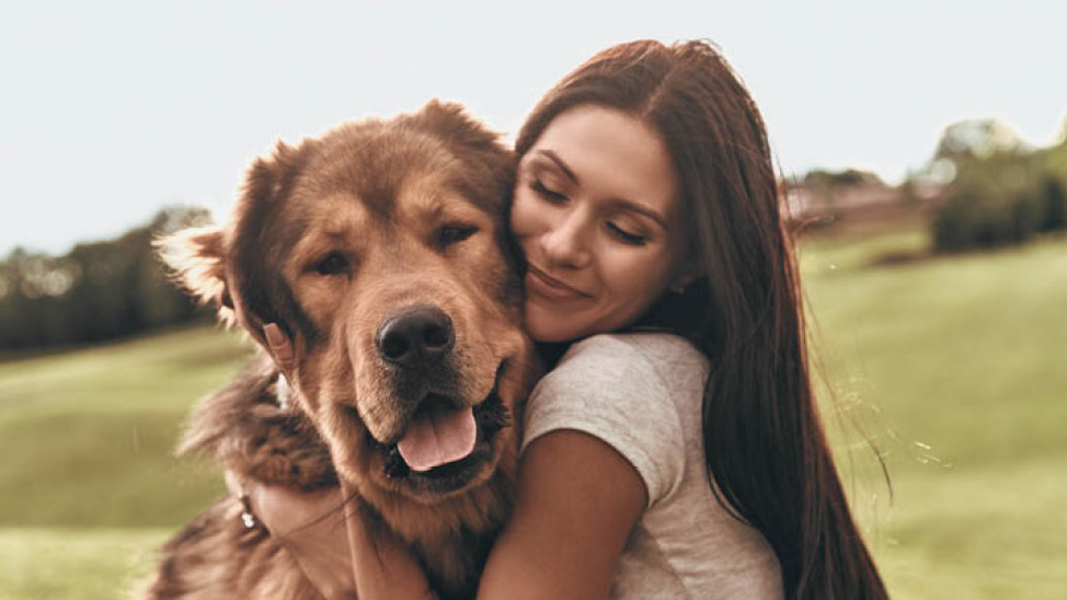 woman hugging big fluffy dog